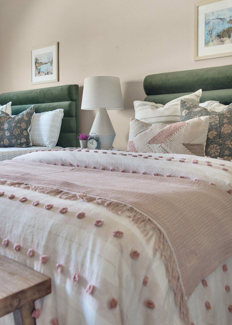 Gray bedroom with green velvet channel headboards