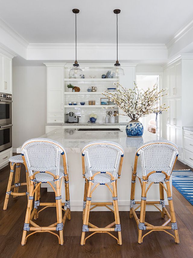 Gray kitchen with blue and white rattan bar stools 