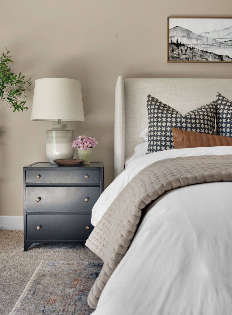 Gray bedroom with navy blue nightstand 