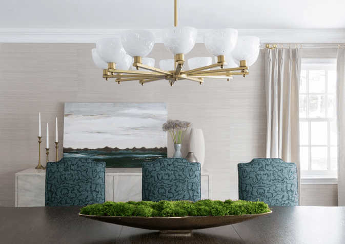 Gray dining room with forest green chairs 