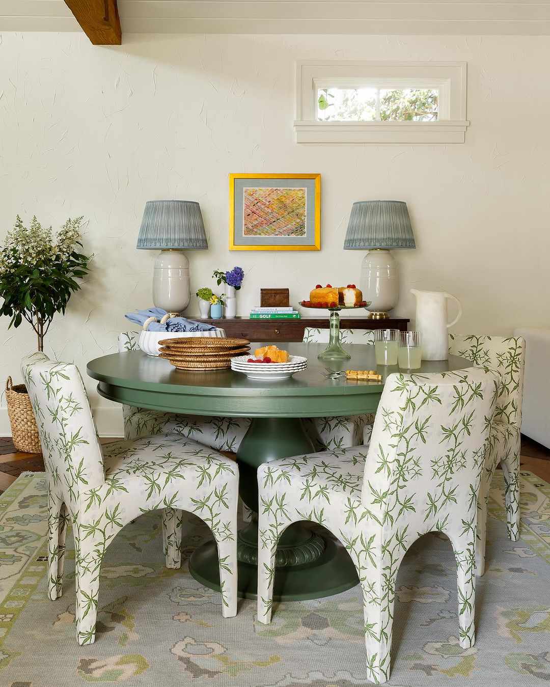Salle à manger avec une table verte et des chaises assorties.