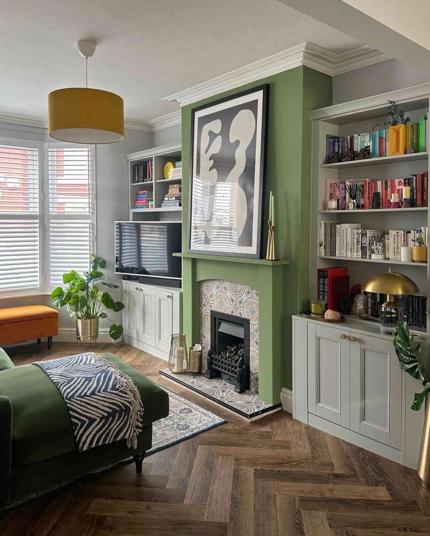 salon vert sauge avec des livres colorés sur un meuble encastré