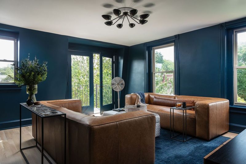 Salon avec peinture murale bleu foncé.