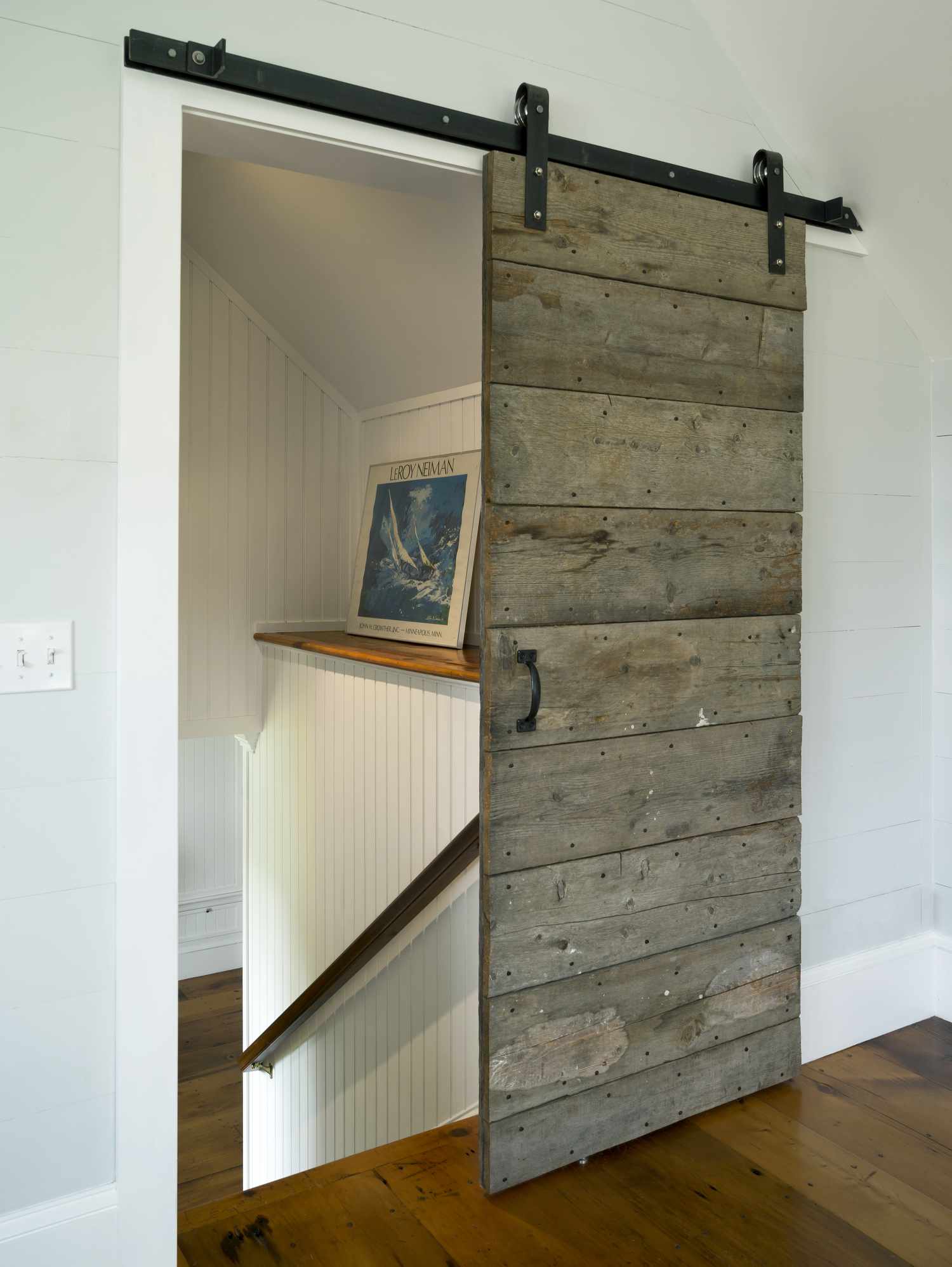 Une porte coulissante est fabriquée à partir de bois recyclé.
