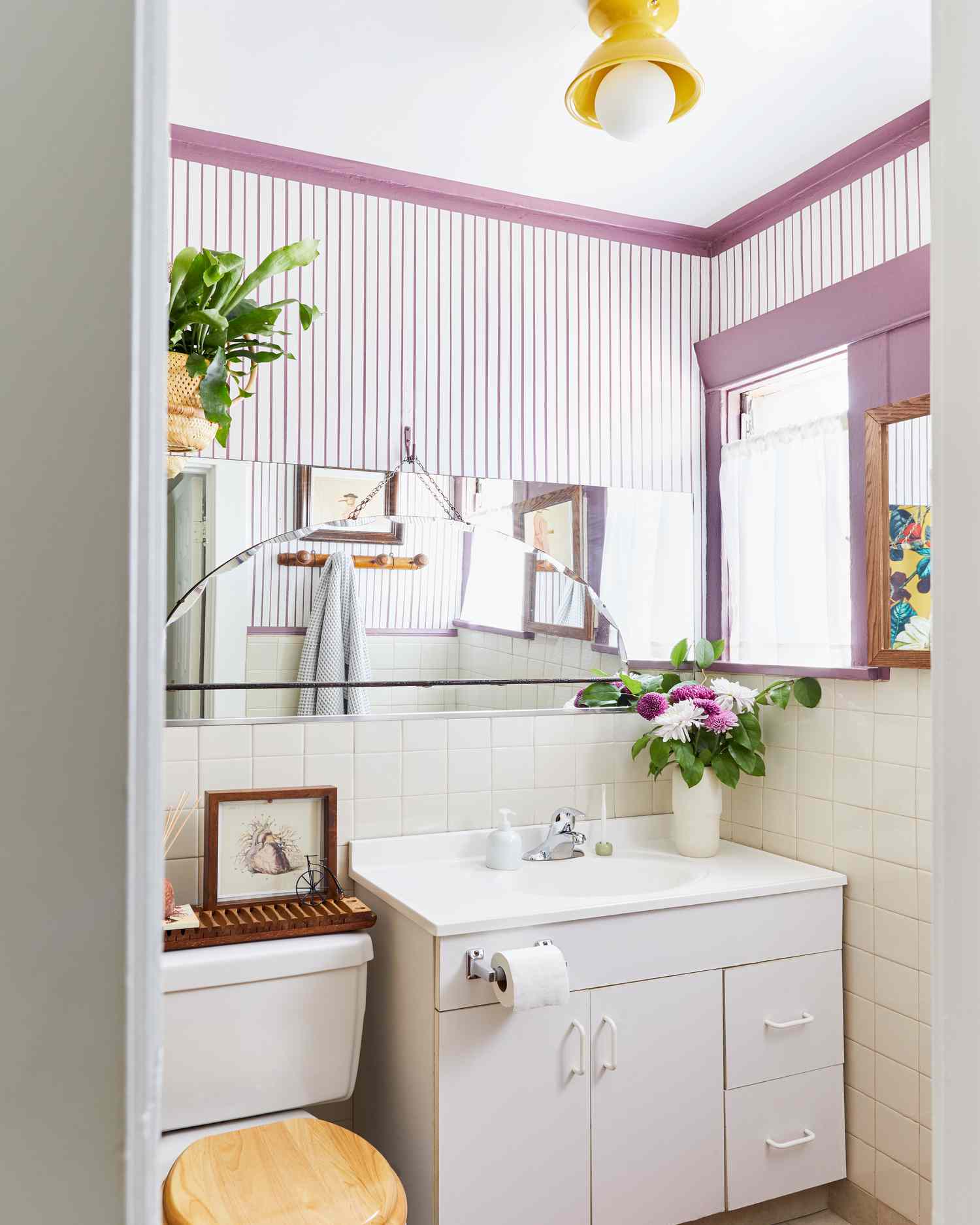 Petite salle de bains avec des rayures et des bordures violettes.