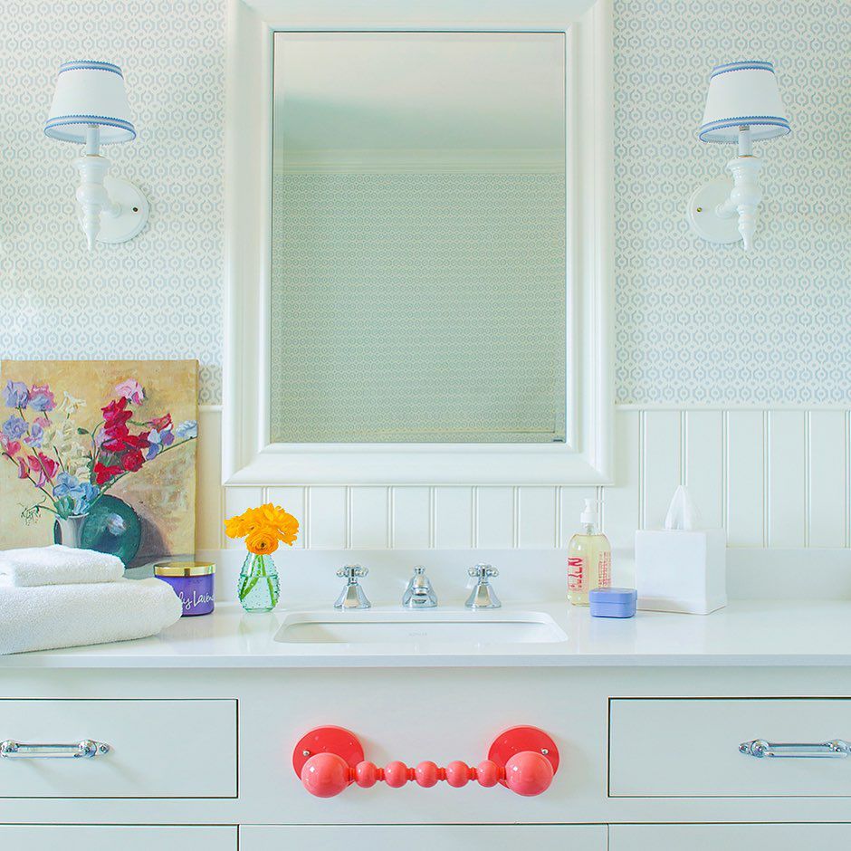 Salle de bain avec papier peint à motifs et porte-serviettes rose