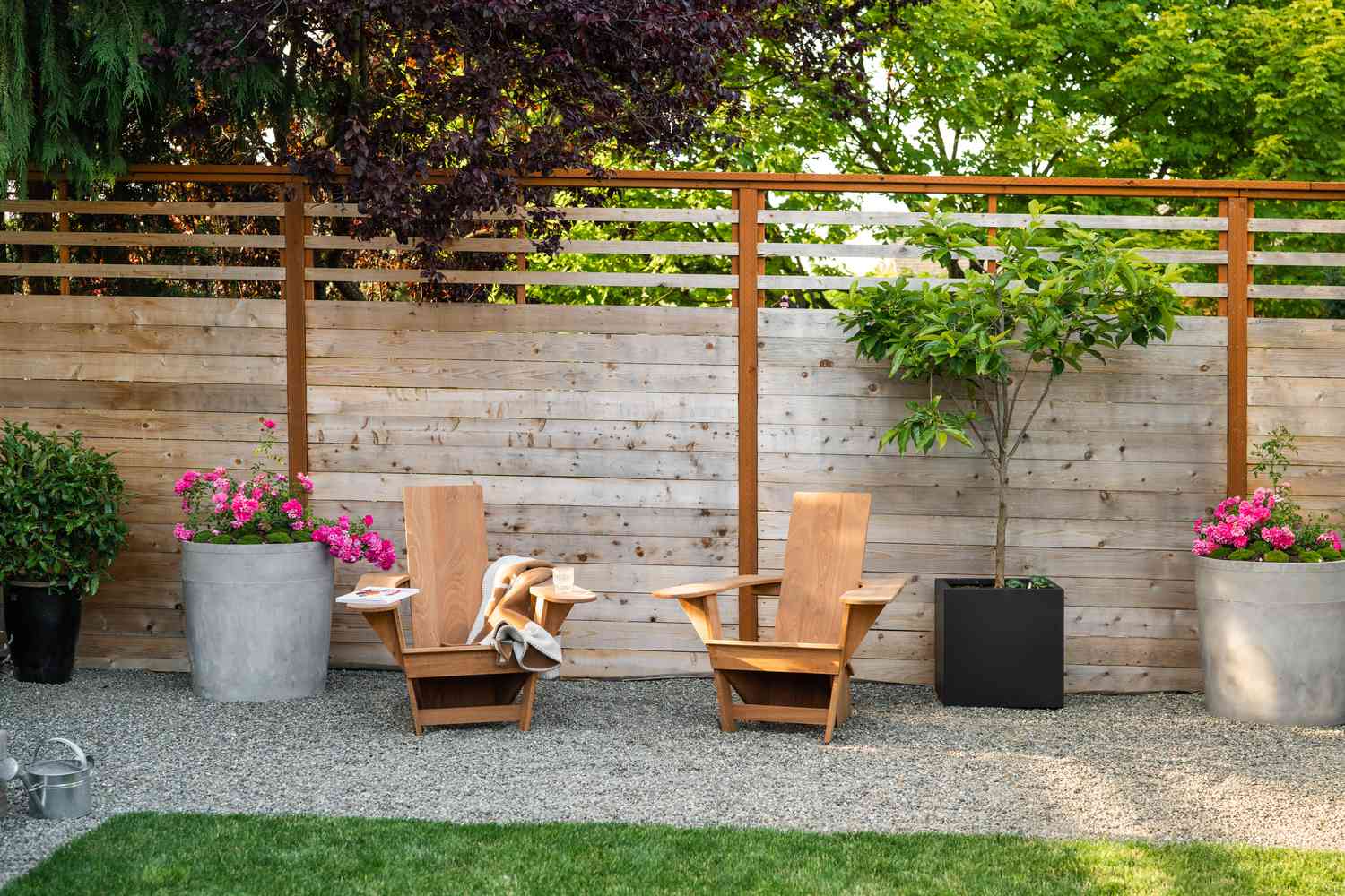 Petit coin salon dans un jardin moderne avec de grandes jardinières.