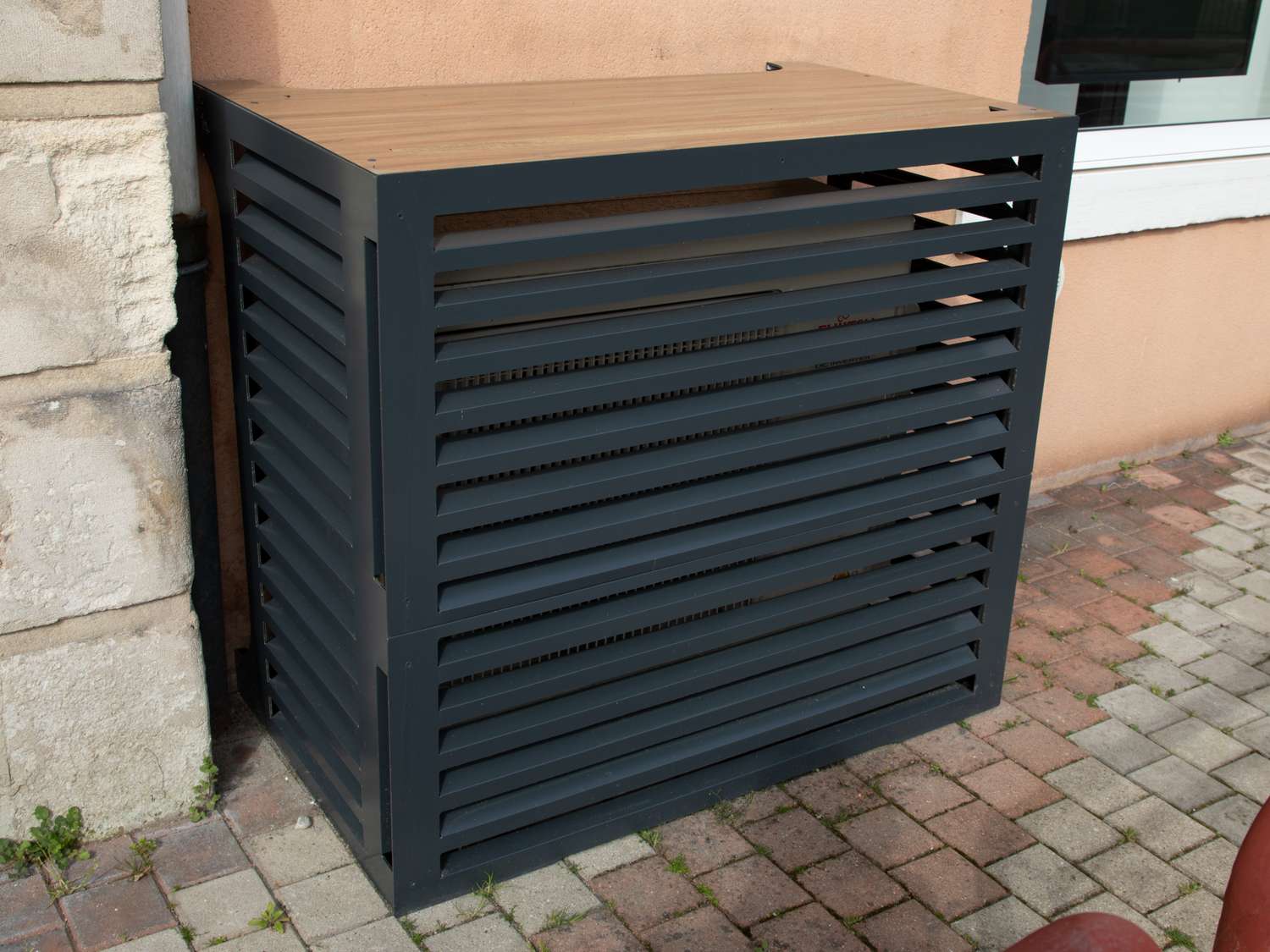 Outdoor air conditioner compressor unit hidden with slatted box cover