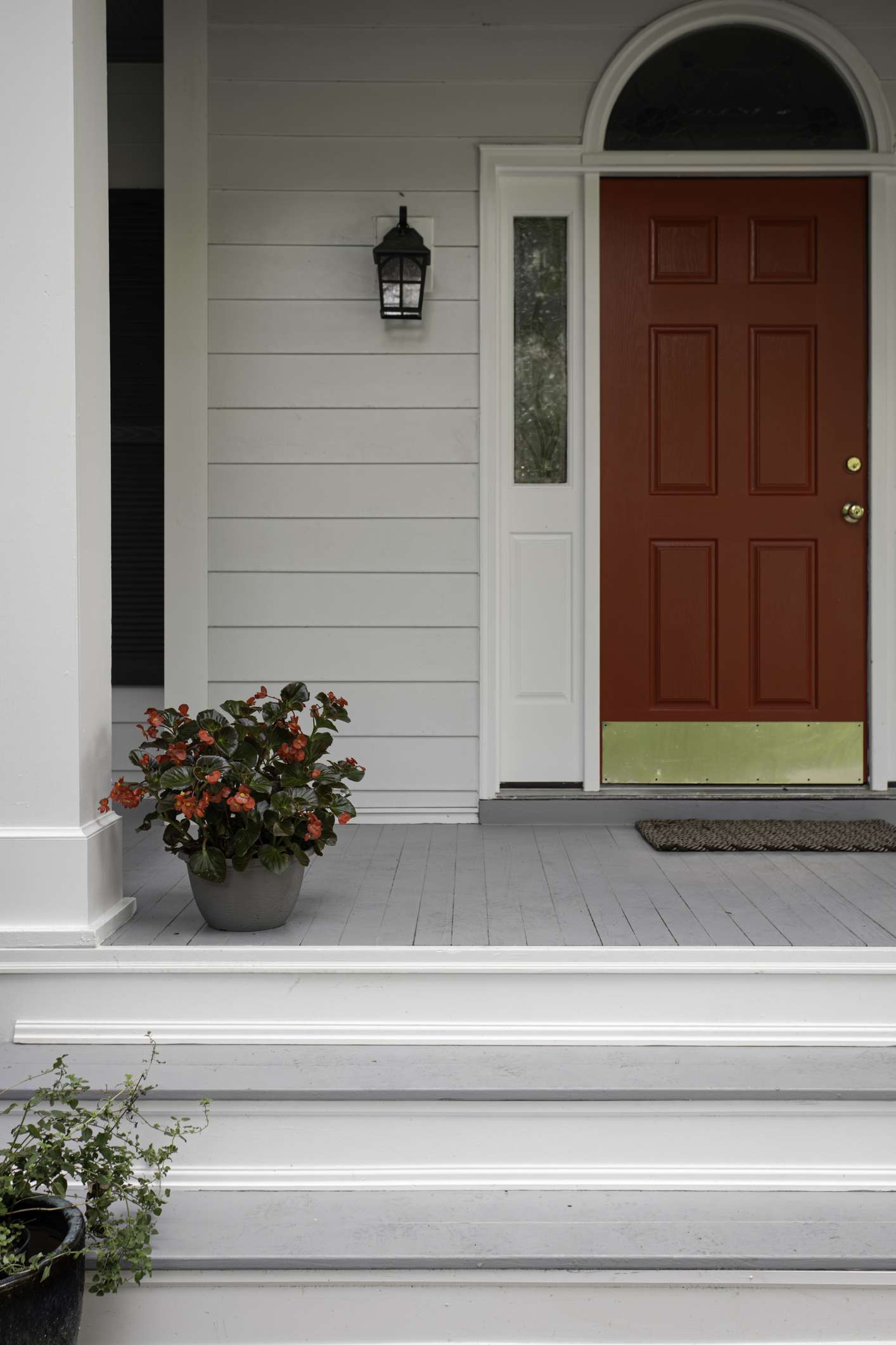 red front door and potted plants
