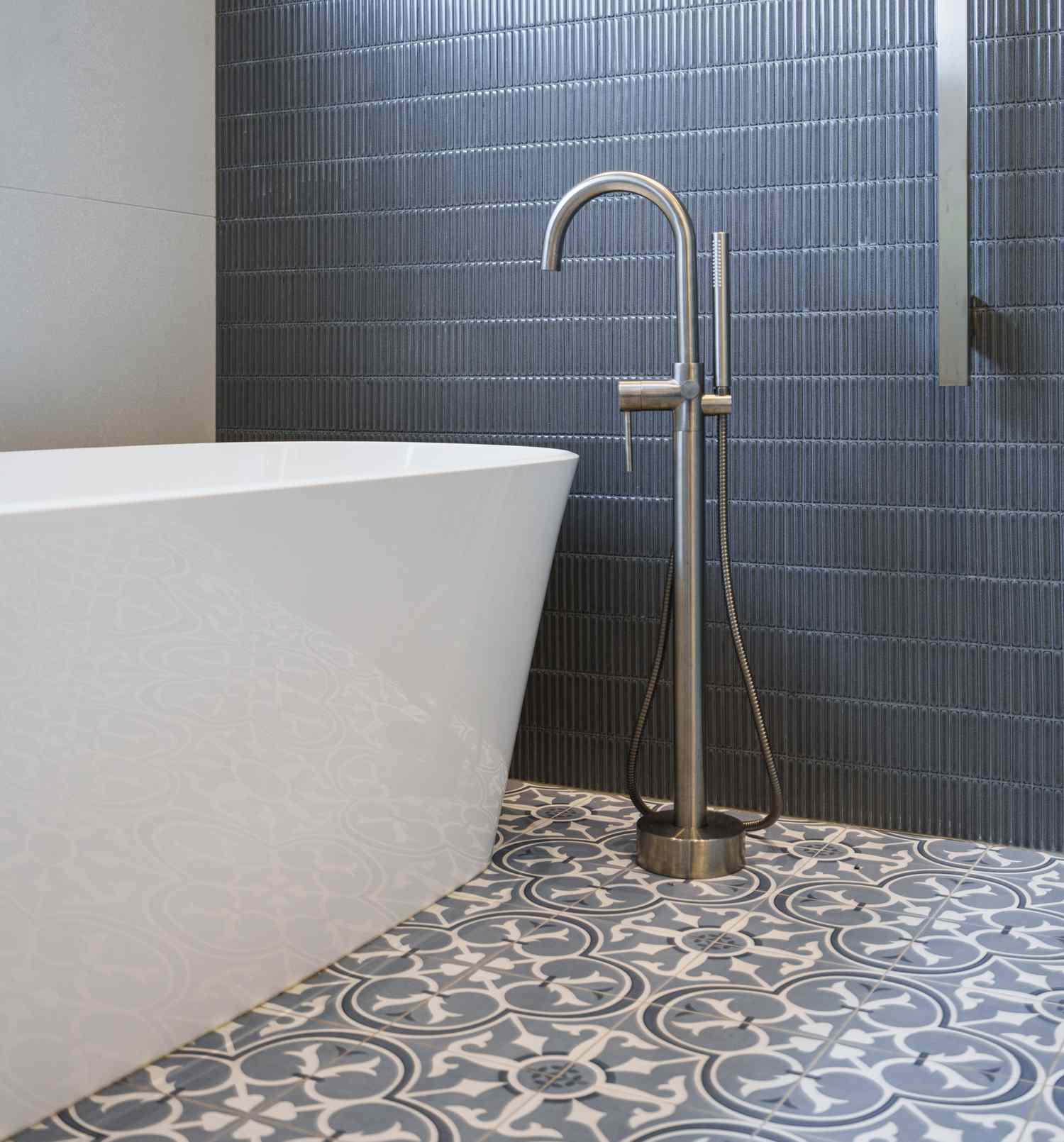 dark vertical tile on the walls of a bathroom