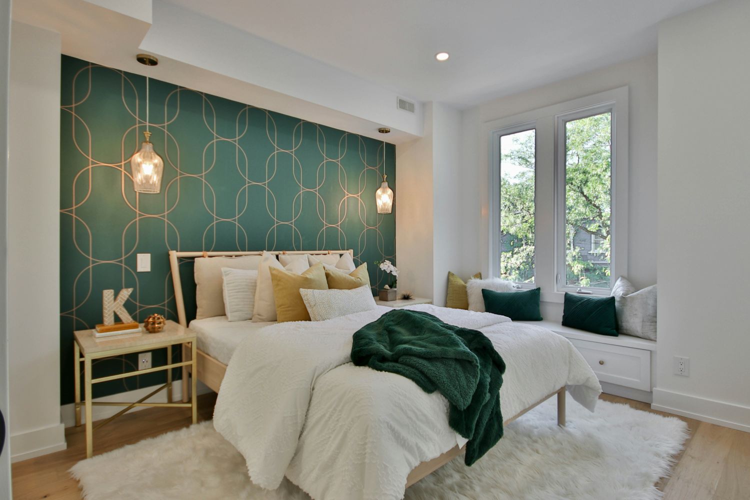 Bedroom with bold wallpaper, harsh lighting, and shag carpet