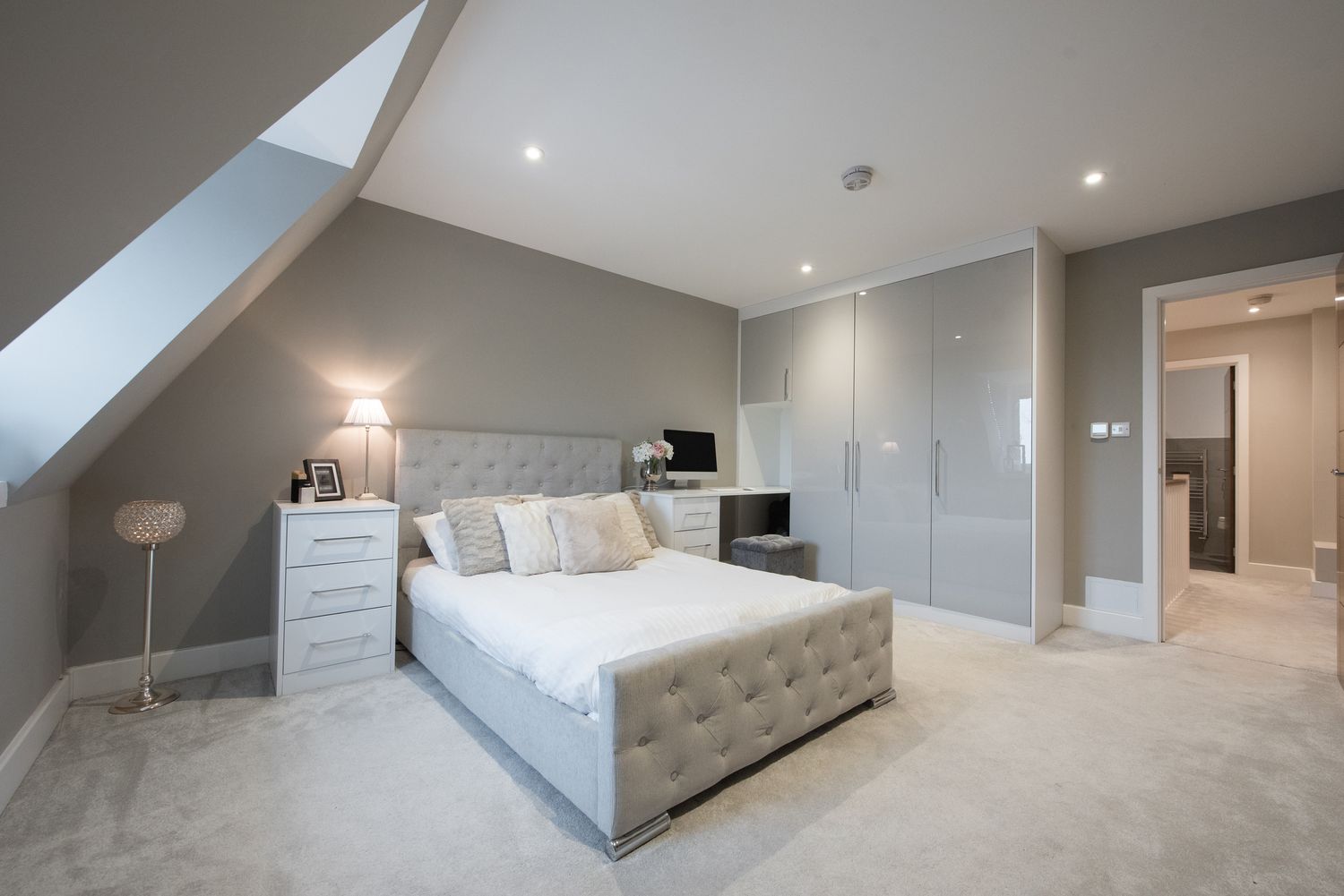 A general interior view of a grey coloured double bedroom within an apartment