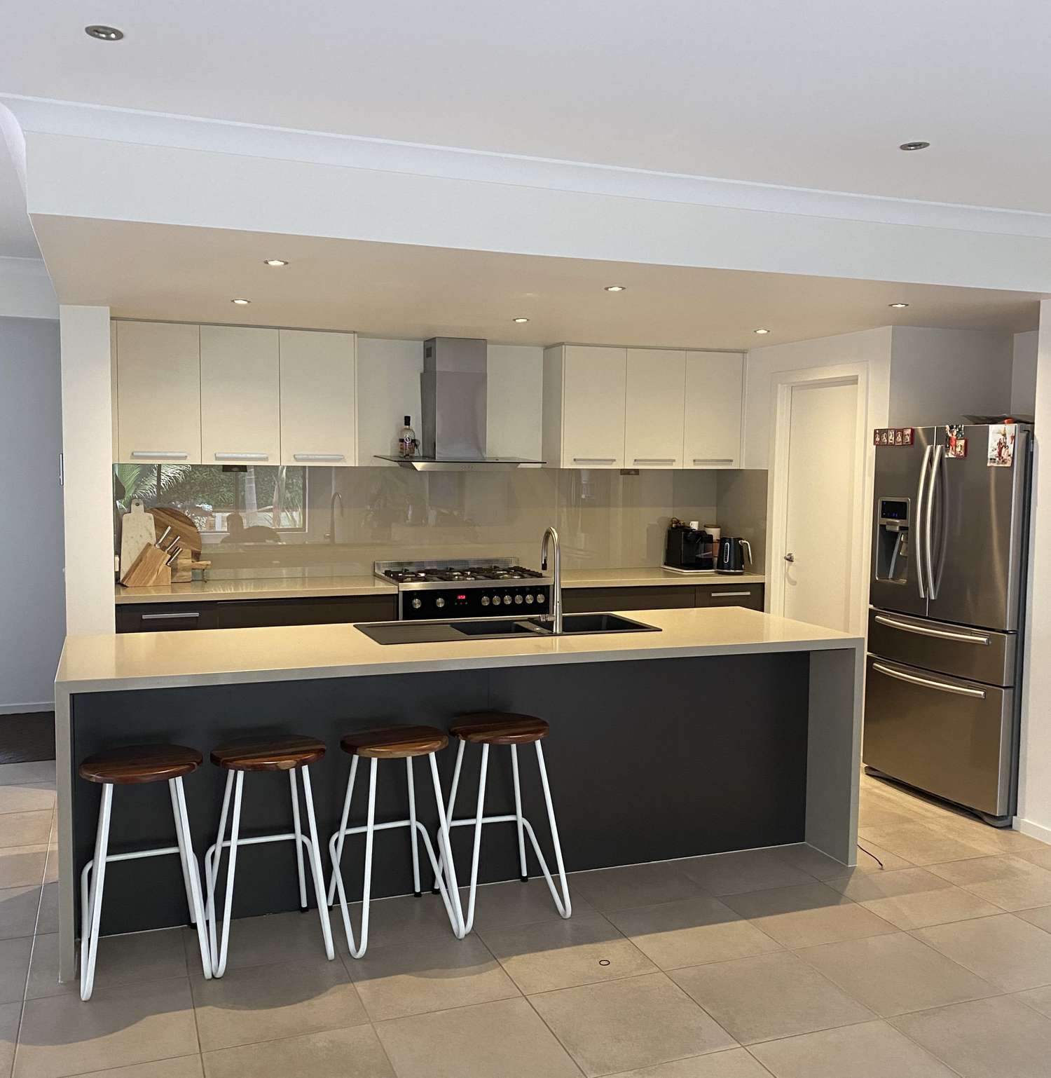 A kitchen with a large island and white cabinetry